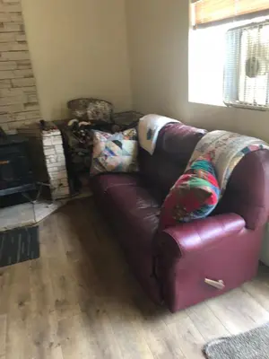 a brown leather couch sitting in a living room at Sequoia National Forest CabinK in Panorama Heights