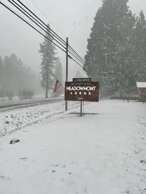 a sign on the side of a road in the snow at Arnold Meadowmont Lodge in Arnold