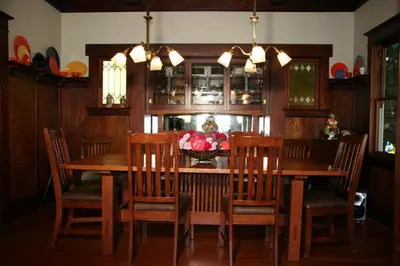 a dining room with a wooden table and chairs at Eureka Street Inn in Sutter Creek
