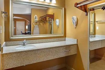 a bathroom with a sink and a mirror at Best Western Exeter Inn & Suites in Exeter