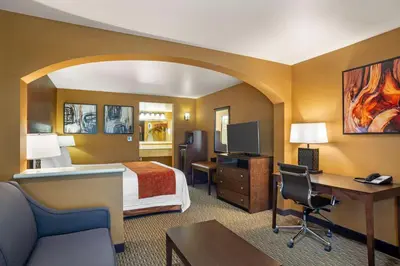 a hotel room with a bed and a desk at Best Western Exeter Inn & Suites in Exeter