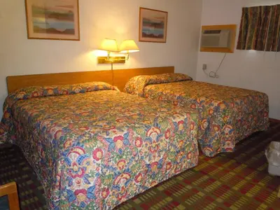 a hotel room with two beds in a room at Value Inn in Fallon