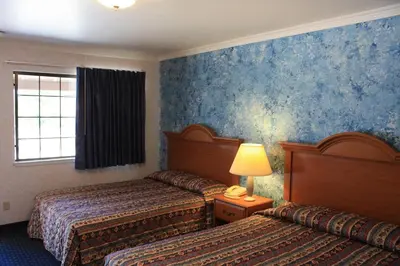 a hotel room with two beds and a window at Mother Lode Motel in Placerville