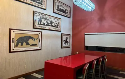a red dining room with a red table and pictures on the wall at Empeiria High Sierra Hotel in Mammoth Lakes
