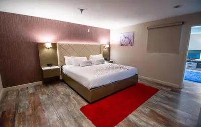 a bedroom with a large bed and a red rug at Empeiria High Sierra Hotel in Mammoth Lakes