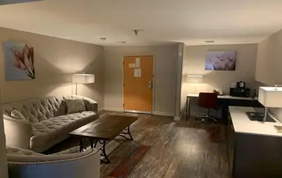 a living room with a couch and a table at Empeiria High Sierra Hotel in Mammoth Lakes