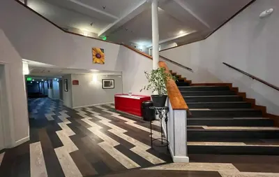 a hallway with stairs and a red table in a building at Empeiria High Sierra Hotel in Mammoth Lakes