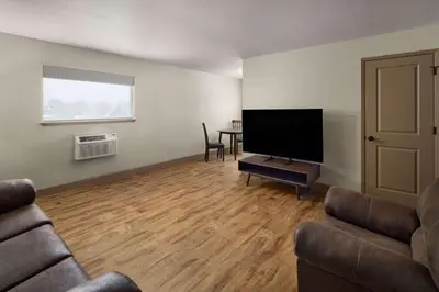 a living room with a couch and a flat screen tv at Super 8 by Wyndham Fallon in Fallon