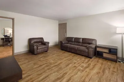 a living room with a couch and two chairs at Super 8 by Wyndham Fallon in Fallon