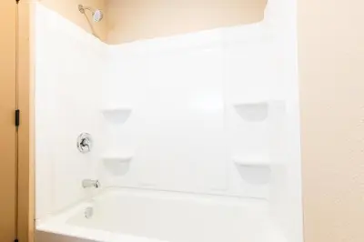 a bathroom with a white bath tub in a room at Super 8 by Wyndham Fallon in Fallon
