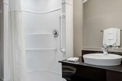 a white bathroom with a sink and a shower at Motel 6-Carson City, NV in Carson City