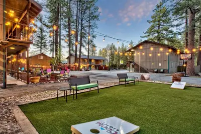 a yard with two benches on the grass at The Alder Inn in South Lake Tahoe