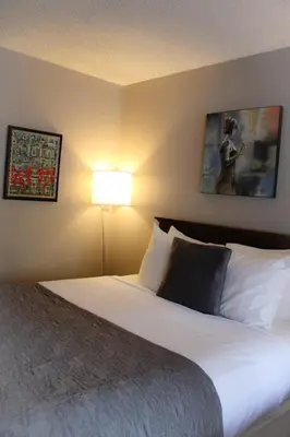 a hotel room with a bed and a lamp at The Alder Inn in South Lake Tahoe