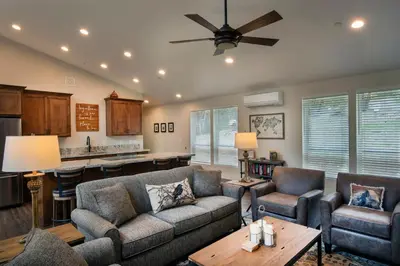 a living room with two couches and a kitchen at 11R Spring Meadow Retreat in Wawona