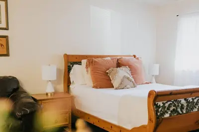 a bedroom with a bed with pillows on it at The Long Barn Lodge in Long Barn