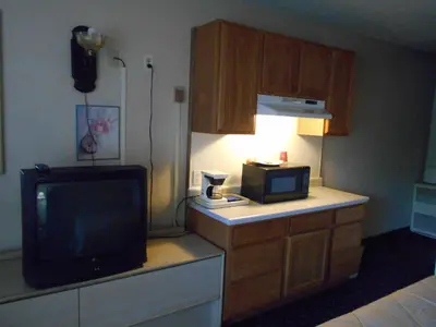 a hotel room with a television and a microwave at Victorian Inn in Reno