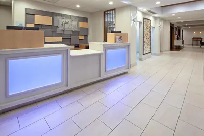 a lobby with two white signs on the wall at Holiday Inn Express & Suites Clovis Fresno Area by IHG in Clovis