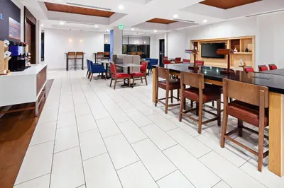 an open dining room with tables and chairs at Holiday Inn Express & Suites Clovis Fresno Area by IHG in Clovis