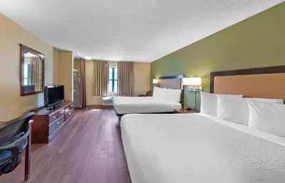 a hotel room with two beds and a flat screen tv at Extended Stay America Suites - Sacramento - Elk Grove in Elk Grove