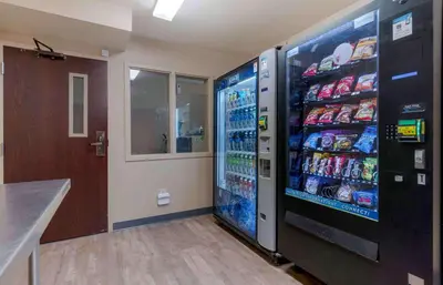 a large soda vending machine in a room at Extended Stay America Suites - Sacramento - Elk Grove in Elk Grove