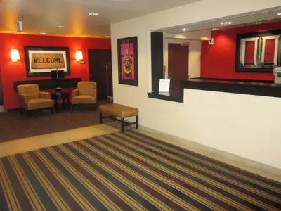 a lobby with a waiting room with red walls at Extended Stay America Suites - Sacramento - Elk Grove in Elk Grove