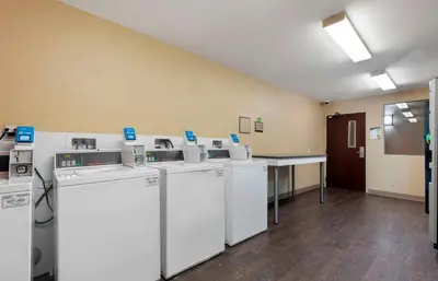 a laundry room with washers and dryers in a room at Extended Stay America Suites - Stockton - March Lane in Stockton