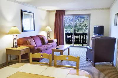 a living room with a couch and a tv at Heidelberg Inn & Resort in June Lake