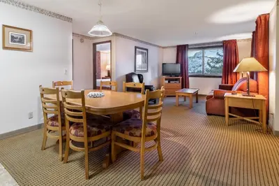 a living room with a table and chairs and a couch at Heidelberg Inn & Resort in June Lake