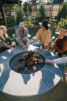 a group of people sitting around a fire pit at Station House Inn South Lake Tahoe in South Lake Tahoe