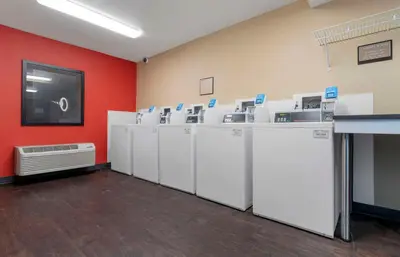 a row of washers and dryers in a room at Extended Stay America Suites - Stockton - Tracy in Tracy