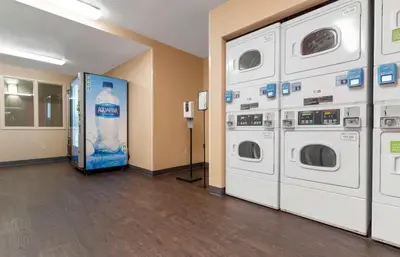 a laundry room with two washers and a vending machine at Extended Stay America Suites - Stockton - Tracy in Tracy