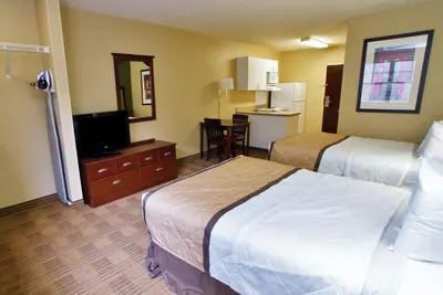 a hotel room with two beds and a flat screen tv at Extended Stay America Suites - Stockton - Tracy in Tracy