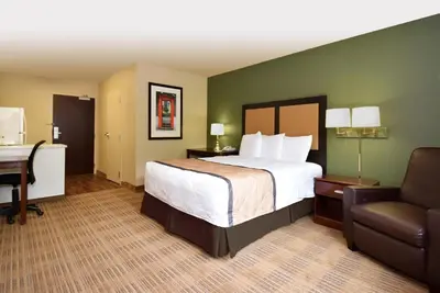 a hotel room with a bed and a desk and a chair at Extended Stay America Suites - Stockton - Tracy in Tracy