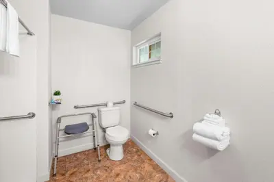 a small bathroom with a toilet and a window at Quality Inn & Suites Jackson in Jackson