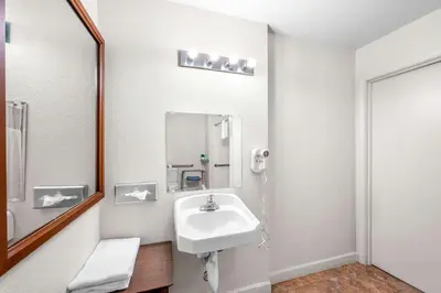 a bathroom with a sink and a mirror at Quality Inn & Suites Jackson in Jackson