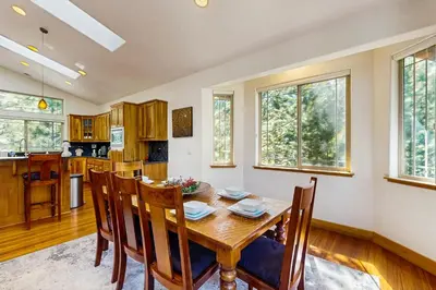 a kitchen and dining room with a wooden table and chairs at Montgomery Estates Retreat in South Lake Tahoe