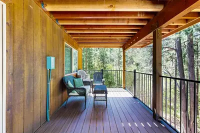 a screened in porch of a house with a table and chairs at Montgomery Estates Retreat in South Lake Tahoe