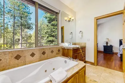 a bathroom with a tub and a window at Montgomery Estates Retreat in South Lake Tahoe