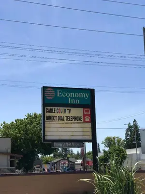 a sign that says economy inn on a highway at Economy Inn in Modesto