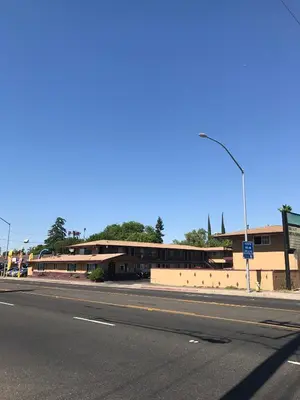 an empty street in front of a building at Economy Inn in Modesto