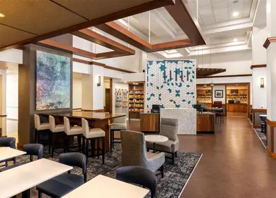 a dining area with tables and chairs in a library at Hyatt Place Sacramento Rancho Cordova in Rancho Cordova