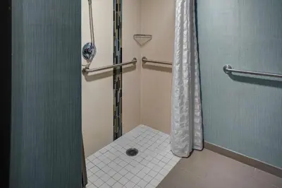 a bathroom with a shower with a glass door at Hyatt Place Sacramento Rancho Cordova in Rancho Cordova