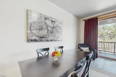 a dining room table with chairs and a painting on the wall at Dolomite Delight in Truckee