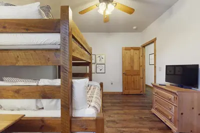 a room with two bunk beds and a television at Dolomite Delight in Truckee