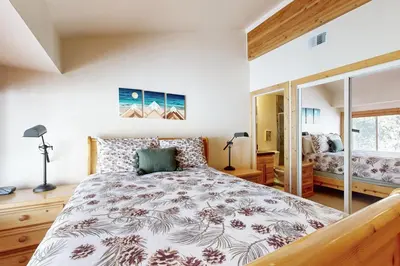 a bedroom with a large bed and a window at Tavern Inn #55 in Olympic Valley