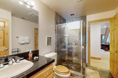 a bathroom with a shower and a toilet and a sink at Tavern Inn #55 in Olympic Valley