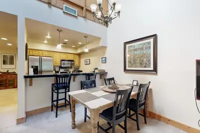 a kitchen and dining room with a table and chairs at Tavern Inn #55 in Olympic Valley
