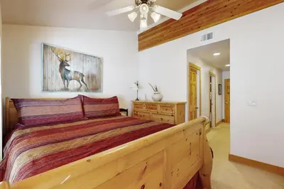 a bedroom with a bed and a painting of a deer at Tavern Inn #55 in Olympic Valley