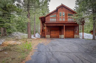 a large wooden house in the middle of a forest at Inviting, Comfortable Mountain Home in Truckee