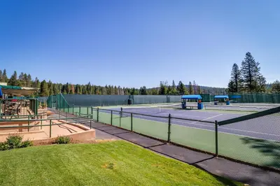 a tennis court with two tennis courts at Inviting, Comfortable Mountain Home in Truckee